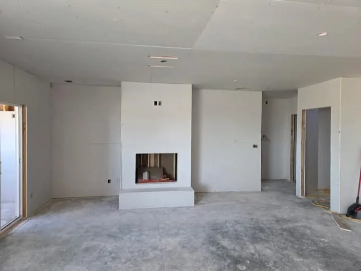 Finished room, textured and painted, fireplace wall done